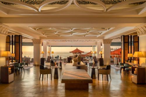 a lobby of a resort with tables and chairs at Hilton Bali Resort in Nusa Dua