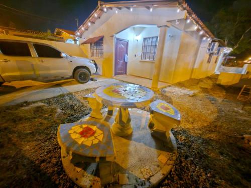 a table in front of a house at night at La Casa Buena Esperanza in Penonomé