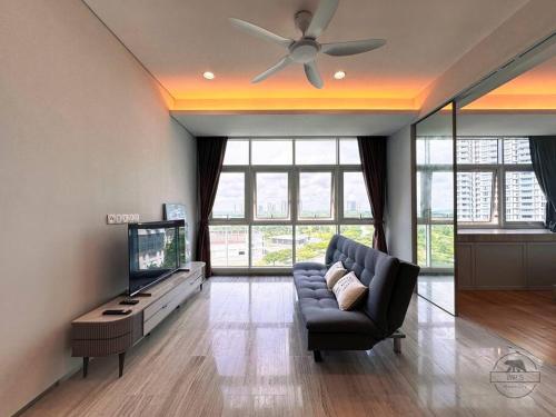 a living room with a couch and a flat screen tv at Pinetree Marina Resort by WP HOMESTAY in Johor Bahru