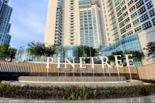 a sign in front of a tall building at Pinetree Marina Resort by WP HOMESTAY in Johor Bahru