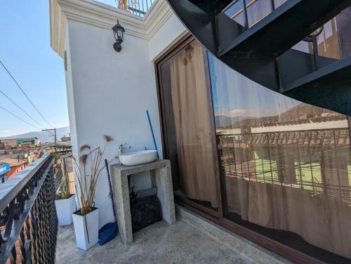 a balcony with a sink on top of a building at Vista Volcan in Antigua Guatemala