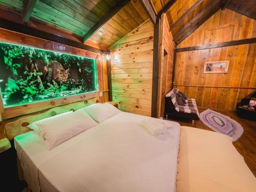 a bedroom with a bed in a room with an aquarium at Costão do Cambará Pousada Fazenda in Cambara do Sul