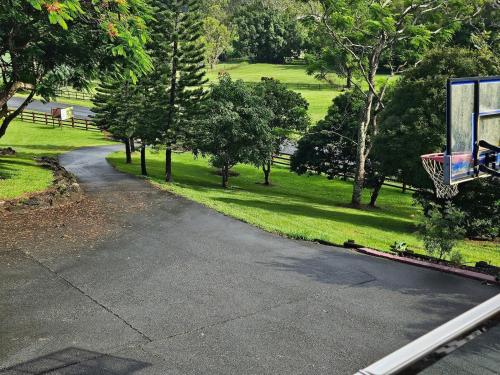 an empty driveway with a basketball hoop in a park at Riverview Homestead 8pp - Bring The Boat! in Dungay