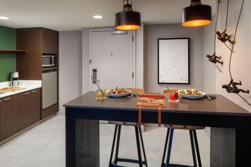 a kitchen with a island with two bowls of food on it at Whitney Peak Hotel Reno, Tapestry Collection by Hilton in Reno