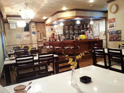 a restaurant with a table with a vase of flowers on it at Fukiya in Gero