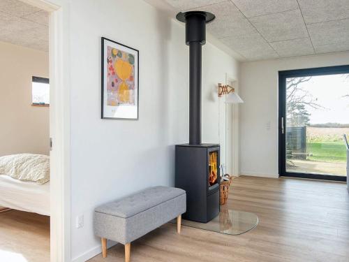a living room with a stove in a room at Beachfront Bliss in Kegnaes - By Traum Ferienwohnungen in Sønderby