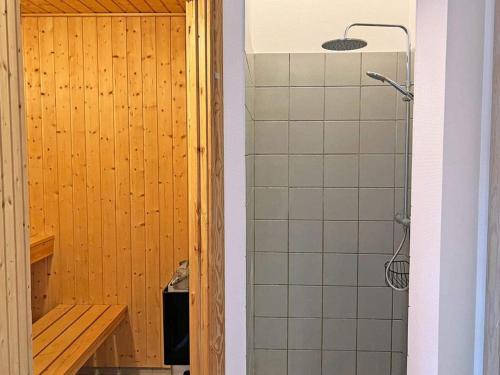 a bathroom with a shower with a bench next to a shower at Holiday home Hasle CIX in Hasle