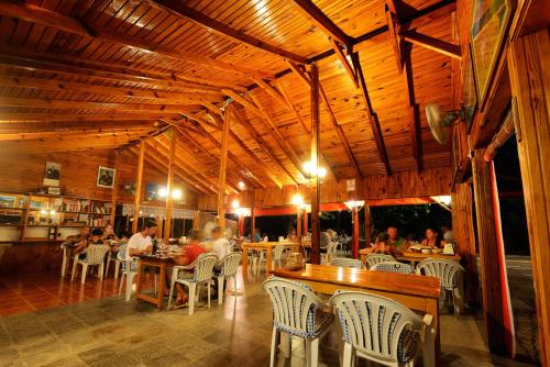 a restaurant with people sitting at tables and chairs at Yildiz Pension Bungalows in Cıralı