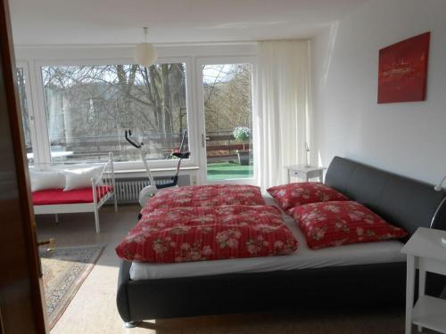 a bedroom with a bed with a red comforter at Holiday apartment dream view 2 in Monschau