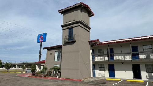 a building with a no sign next to a parking lot at Motel 6-Beaumont, TX in Beaumont