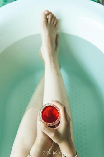 a woman laying in a bath tub with her feet up at Simatai No.19 Villa in Miyun