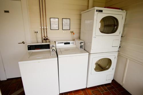 a laundry room with two washer and dryer at Canberra Ave Villas in Queanbeyan