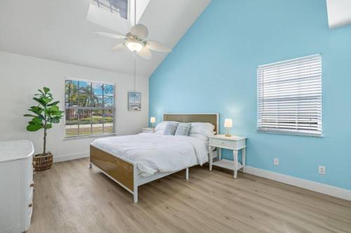 a bedroom with a bed and a blue wall at Secluded Backyard Home with Hot Tub & Pool - 3BR & 2B in Fort Myers