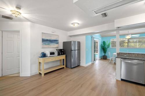a kitchen with a stainless steel refrigerator and a counter at Secluded Backyard Home with Hot Tub & Pool - 3BR & 2B in Fort Myers