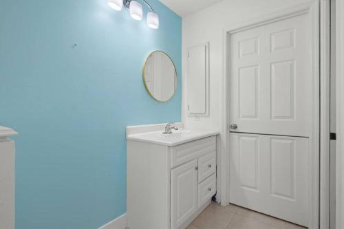 a bathroom with a white sink and a mirror at Secluded Backyard Home with Hot Tub & Pool - 3BR & 2B in Fort Myers