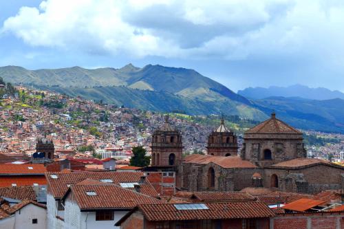 a view of a city with mountains in the background at The Chusay Rooftop in Cusco