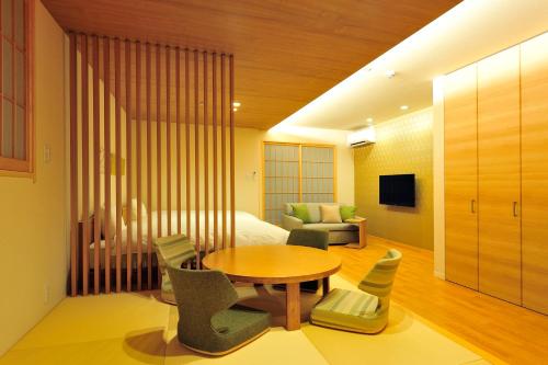 a hotel room with a bed and a table and chairs at Rakuten STAY x Shamaison Osaka Dekijima Station in Osaka
