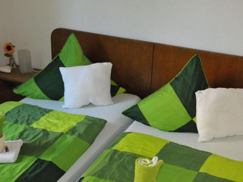 Una cama con almohadas verdes y negras. en Holiday apartment Boldin, for 4 people, 