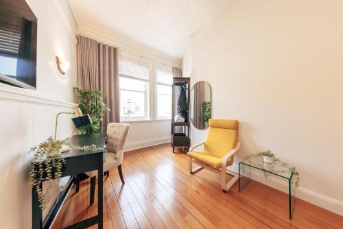 a living room with a desk and chairs and a mirror at Gaslight Inn - Adults Only in Sydney