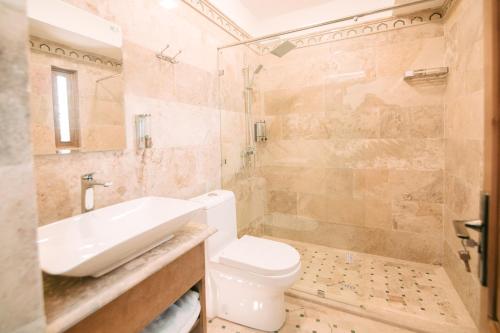 a bathroom with a toilet and a sink and a shower at Istat Boutique Hotel in Bukhara