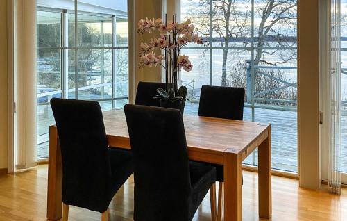 a dining room with a wooden table and chairs at Stunning Home In Värnamo With Sauna in Värnamo