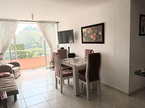 a dining room with a table and chairs and a window at Linda habitación1 en Florida in Floridablanca