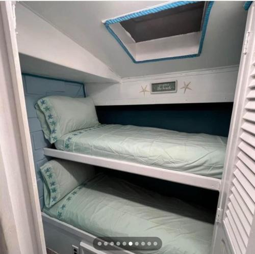 a small room with two bunk beds in it at Dock life in Marathon