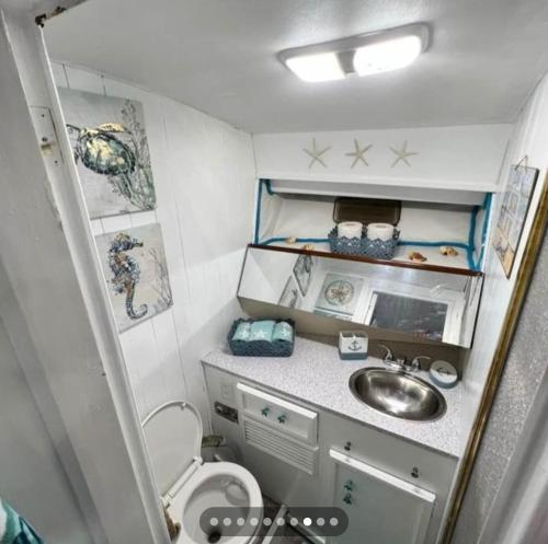 a small bathroom with a sink and a toilet at Dock life in Marathon