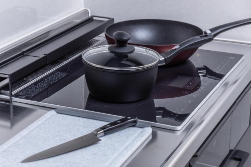 a black pot on a stove with a knife at HIDA TAKAYAMA BASE - Traditional Japanese Garage House with Private Sauna in Takayama