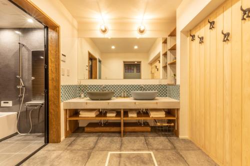a bathroom with two sinks and a mirror at HIDA TAKAYAMA BASE - Traditional Japanese Garage House with Private Sauna in Takayama