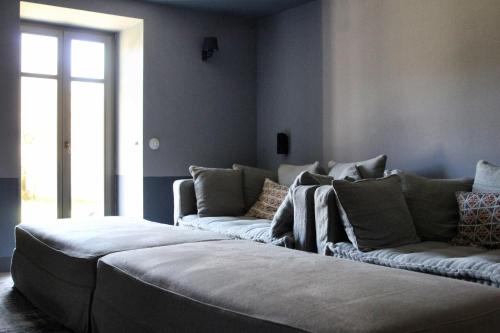 a living room with two couches and a window at "Apeiros Chora" Hotel, Zagori in Kato Pedina