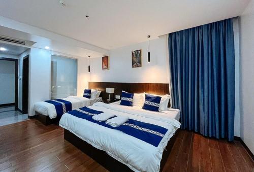 Ліжко або ліжка в номері YY City Garden Hotel Arayat Pampanga
