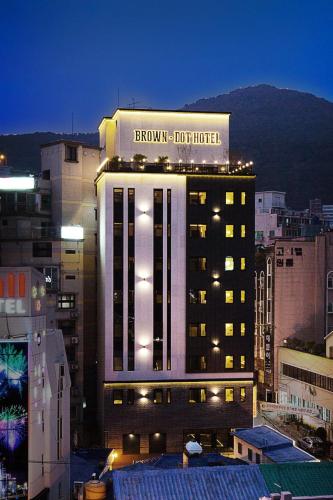a hotel building with a sign on top of it at Brown Dot Hotel Busan Station in Busan
