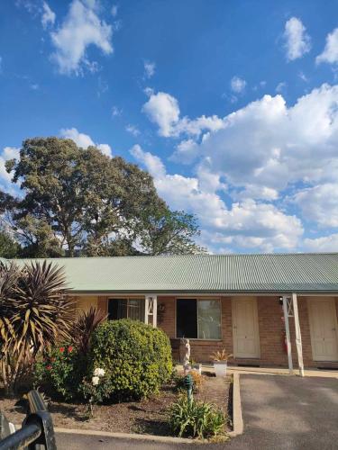 a brick house with a green roof at Kandos Hotel in Kandos