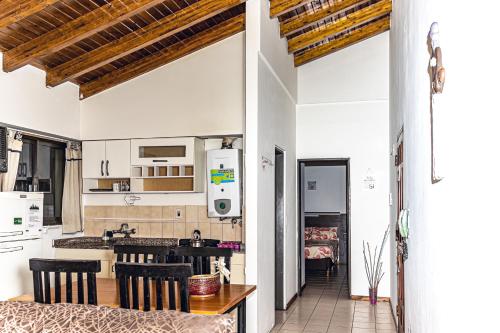 a kitchen and dining room with a table and chairs at Depto mitre in Mendoza