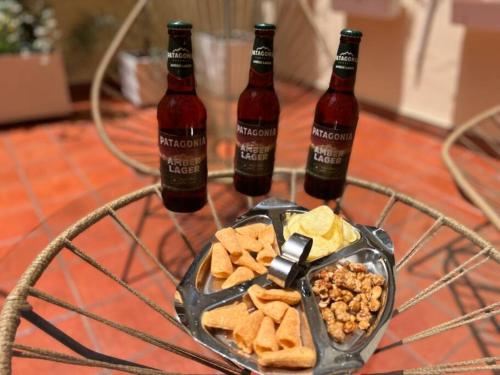 two bottles of beer and a bowl of crackers and snacks at Gem! New Condo 4 Blocks From Puerto Madero in Buenos Aires