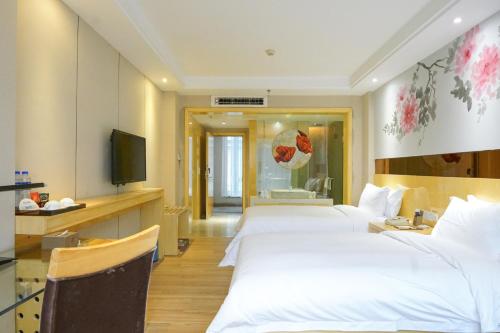 Ένα ή περισσότερα κρεβάτια σε δωμάτιο στο Paco Hotel Ouzhuang Metro Guangzhou-Free shuttle to Canton fair