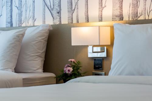 a bedroom with a bed and a chair and a lamp at GLOW Ao Nang Krabi in Ao Nang Beach