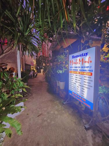 a sign on the side of a building with plants at Minh Minh Homestay in Con Dao