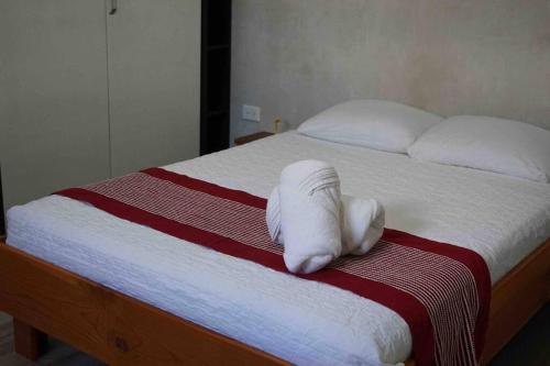 a white towel is laying on a bed at Garden Suite 1 Estación 48 in Mérida