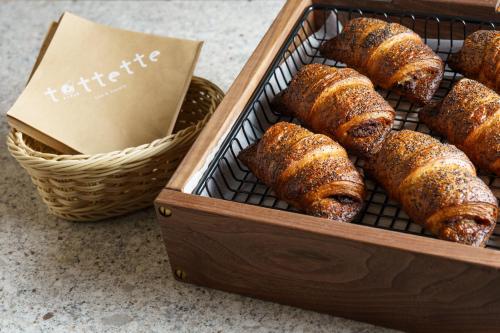a box of pastries on a rack next to a basket at the b sapporo in Sapporo