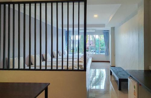 a room with a staircase with a bed and a bench at Phornpailin Riverside Resort in Sangkhla Buri