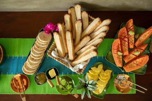 a tray of french bread and chips and other foods at Tranquil Waters in Negombo