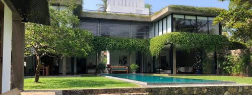 an external view of a house with a swimming pool at Tranquil Waters in Negombo