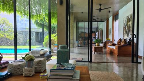a living room with a couch and a table with books at Tranquil Waters in Negombo