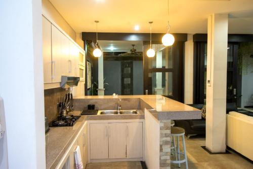 a kitchen with a sink and a counter top at Villa cinta buana 1 in Legian