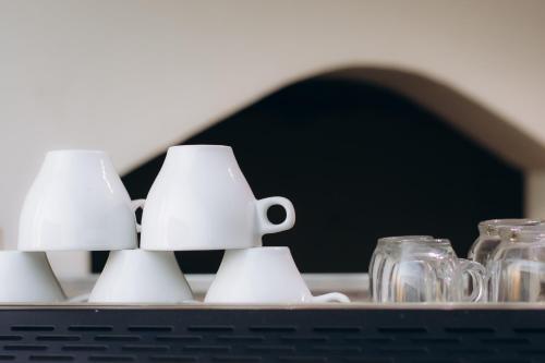 two mason jars and two mugs on a table at Regent Pyramids View in Cairo