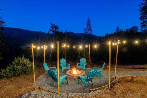 a group of chairs around a fire pit at night at Yosemite's Scenic Hideaway in Midpines