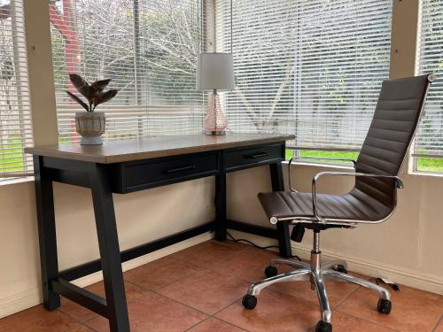 a desk with a chair next to a window at Saikwan Valley Family Home in Milpitas