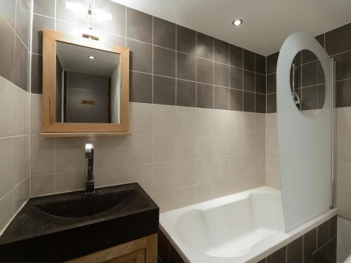 une salle de bain avec un lavabo noir et un miroir dans l'établissement Studio rénové pied de pistes, balcon sud, 4 pers - FR-1-181-2557, à Aime La Plagne